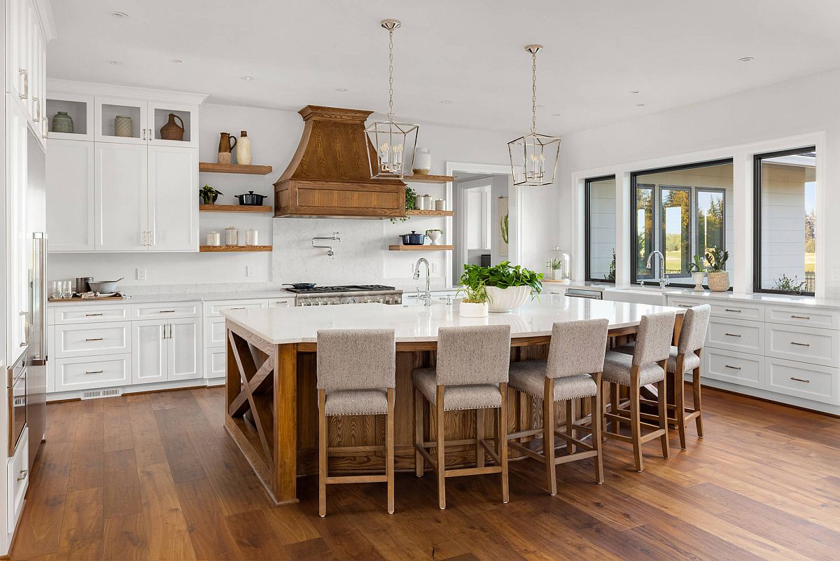 Wooden hood adds that something different to the white kitchen