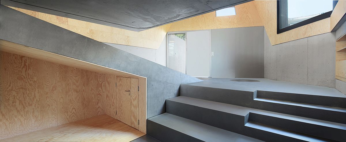 A mix and staircase and ramp inside the home makes for an interesting visual