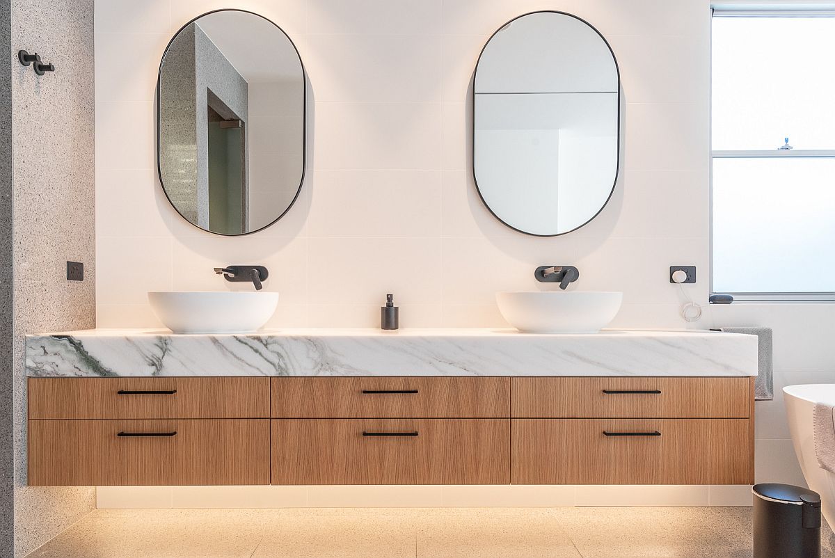 Add a marble countertop to the floating wooden vanity in the contemporary bathroom