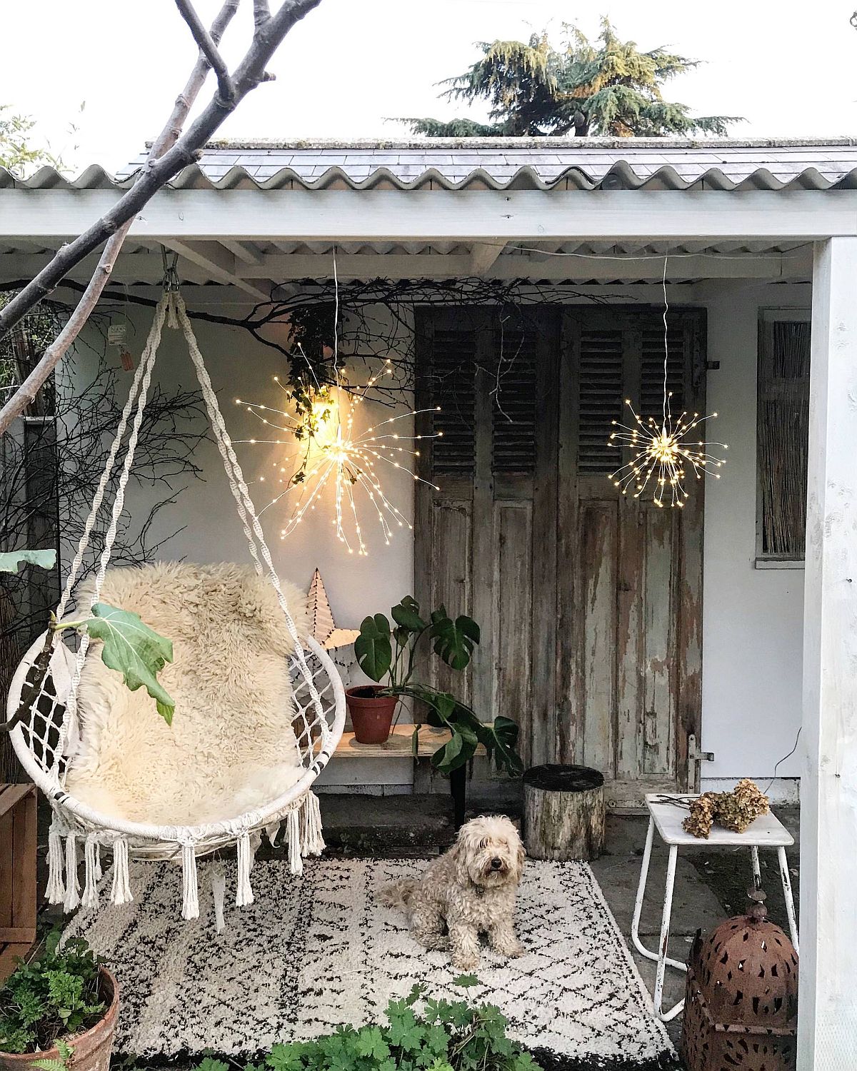 An eclectic mix of decor coupled with greenery creates this relaxing shabby-chic patio