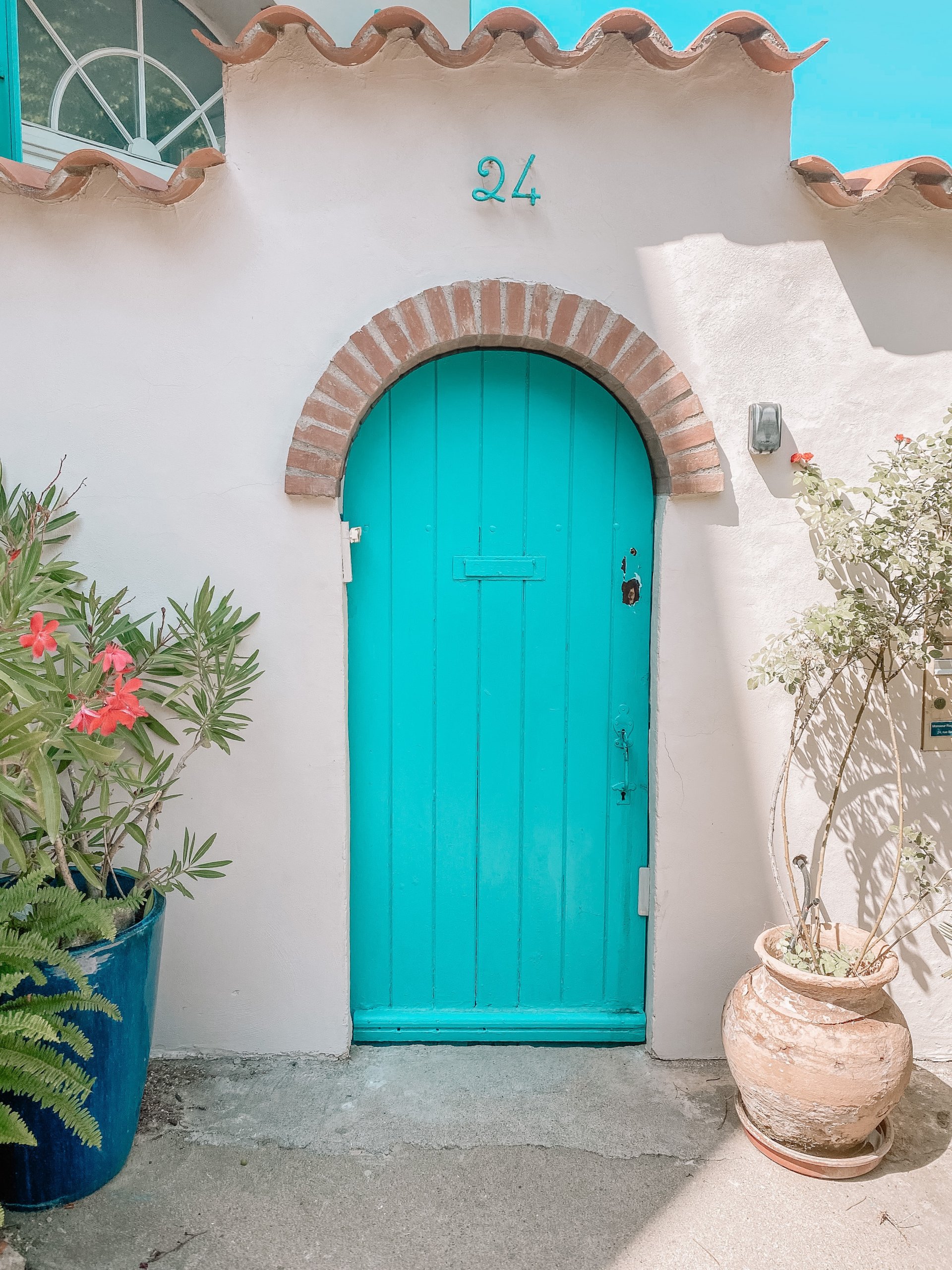 Arched blue door with number 24