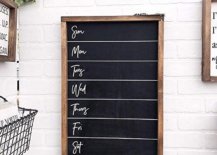 Blank weekly menu chalkboard on white brick wall