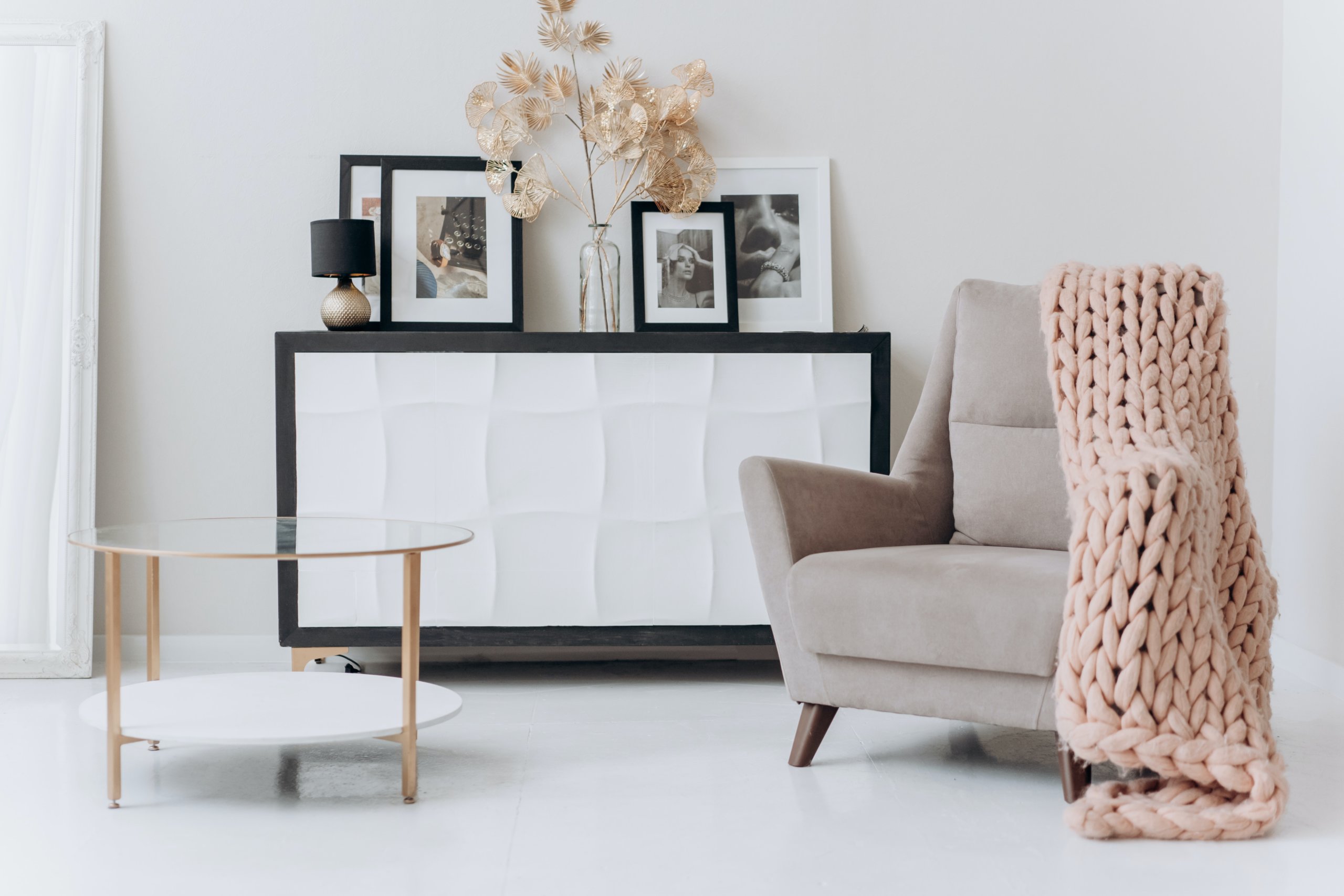 Braided blanket on brown chair and glass round table on the side