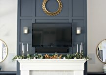 Candles and plants on top of white mantel and fireplace