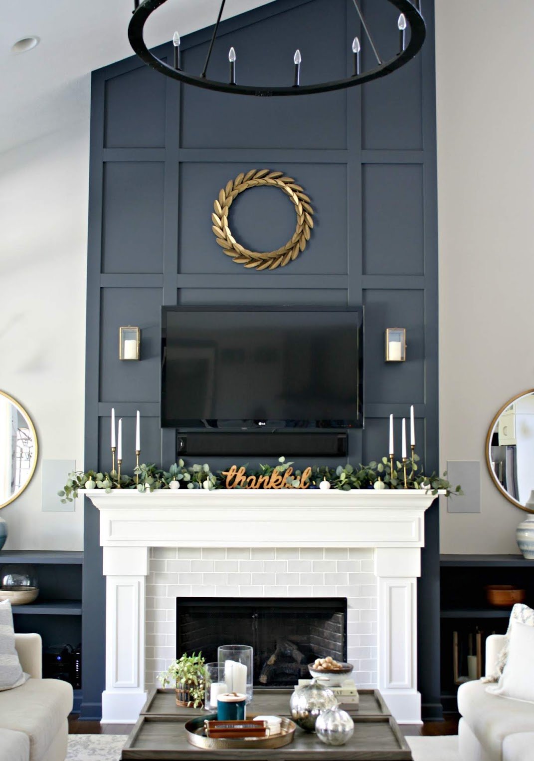 Candles and plants on top of white mantel and fireplace