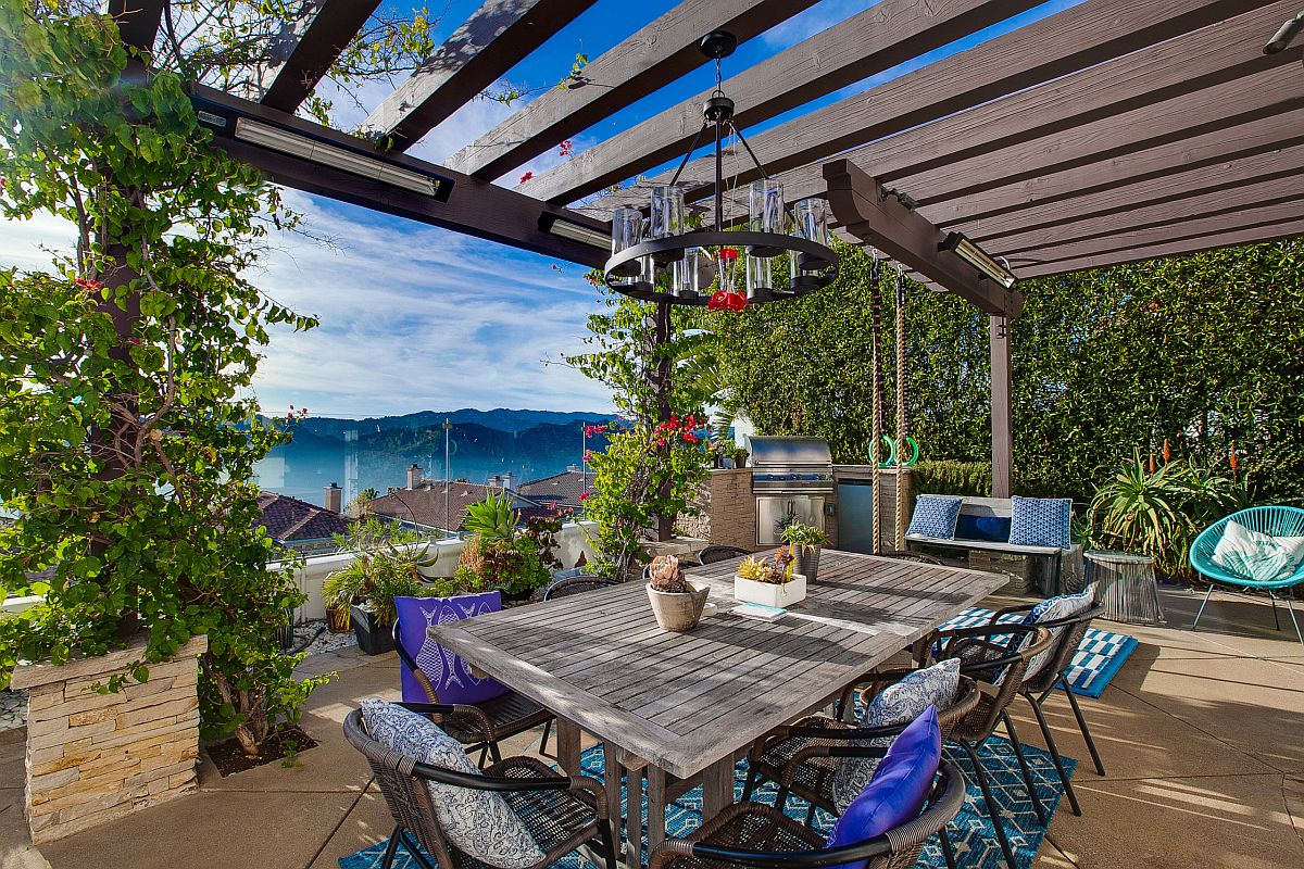 Captivating views and a wall of green steal the spotlight at this Mediterranean patio