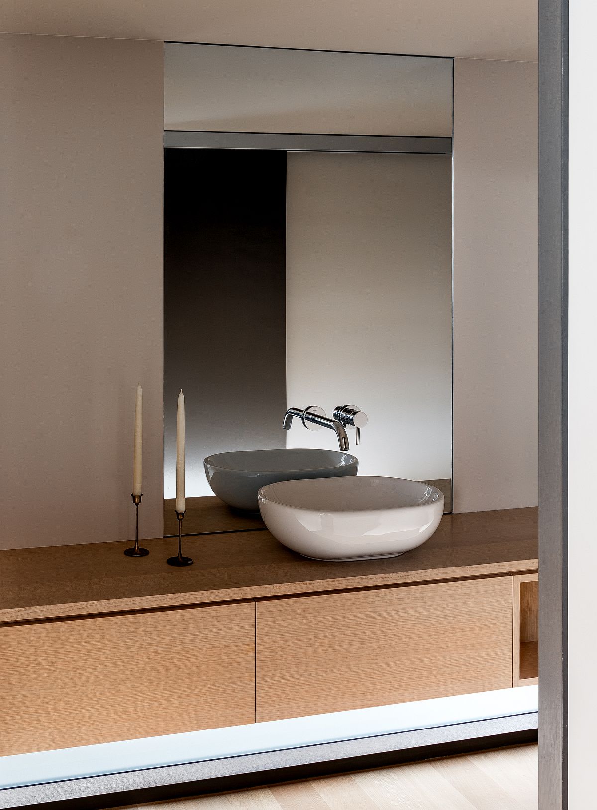 Contemporary bathroom with a sleek wooden vanity and a neutral color scheme
