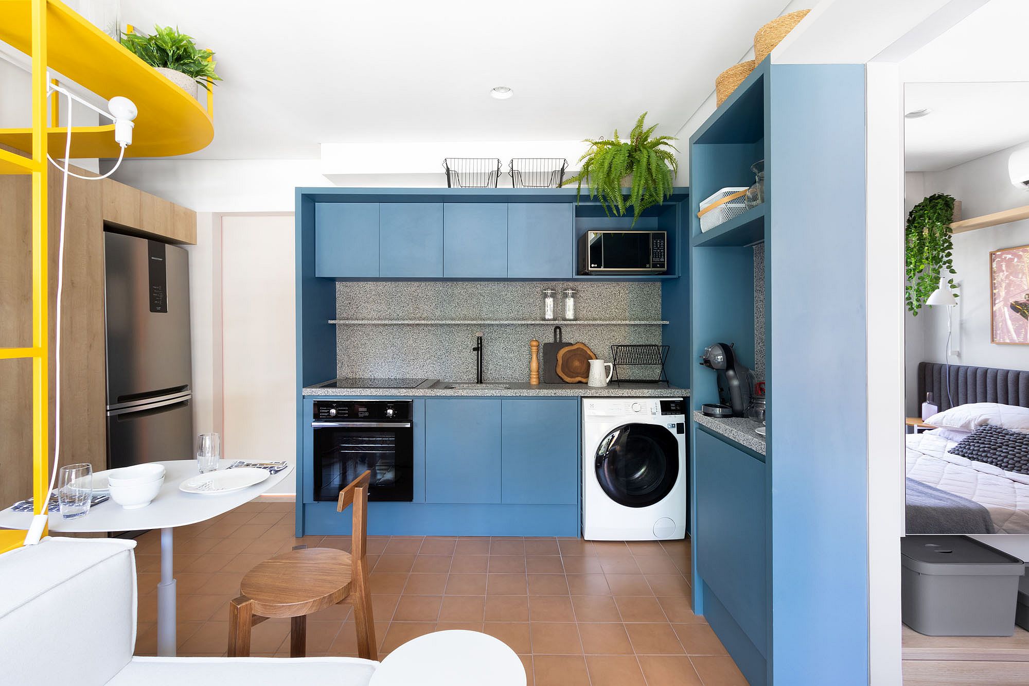 Custom blue cabinets combined with granite countertops in the space-savvy kitchen