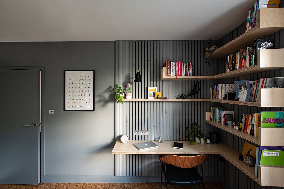 Custom floating shelves in wood along with the desk bring ergonomic ease to this home office