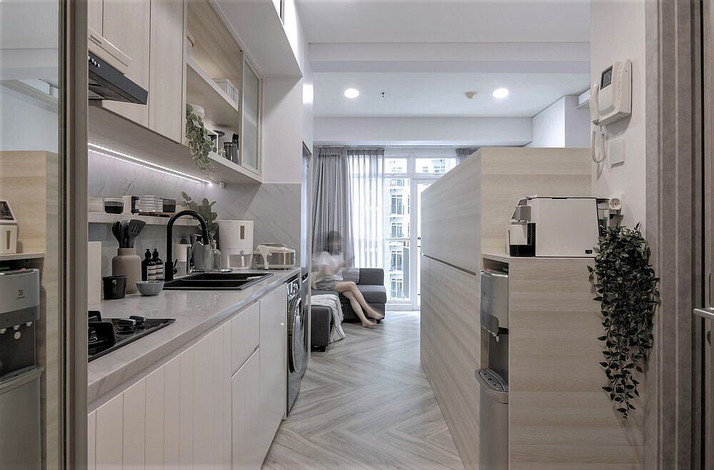 Custom wooden platform with queen size bed above becomes the bedroom inside the apartment