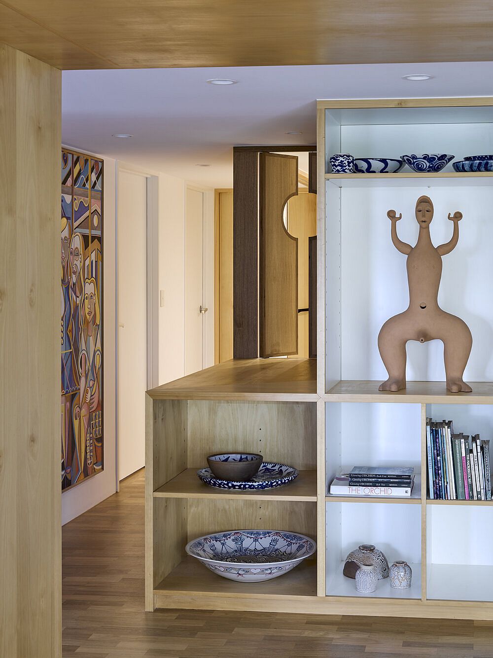 Custom wooden shelf inside the apartment brings additional storage space to the living area