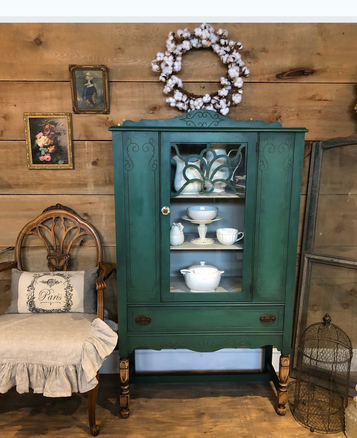 Dark green cabinet with white china