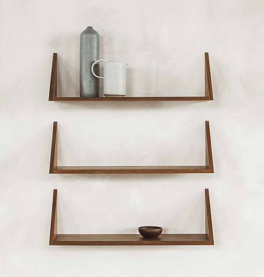 Different ways to decorate the slim oak wooden shelves next to the wall-mounted desk