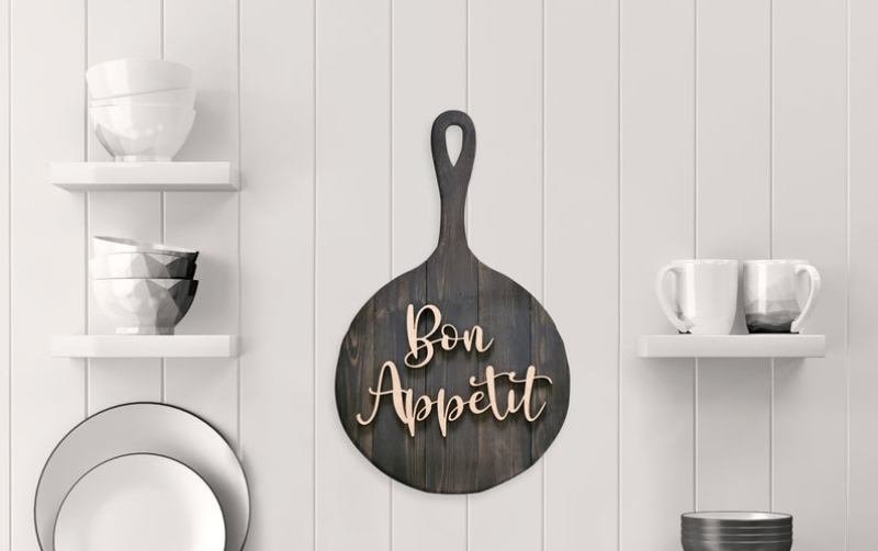 Frying pan kitchen wall decor in the middle of a white wall