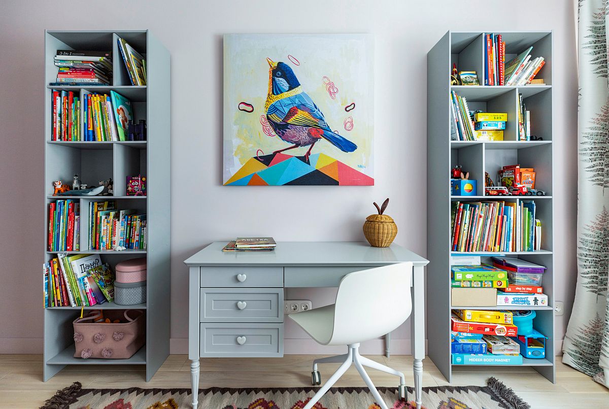 Gorgeous kids' study space in light, pastel blue coupled with ample storage space in the form of open shelves