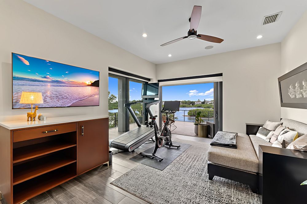 Gray and white home gym with views that end up stealing the spotlight