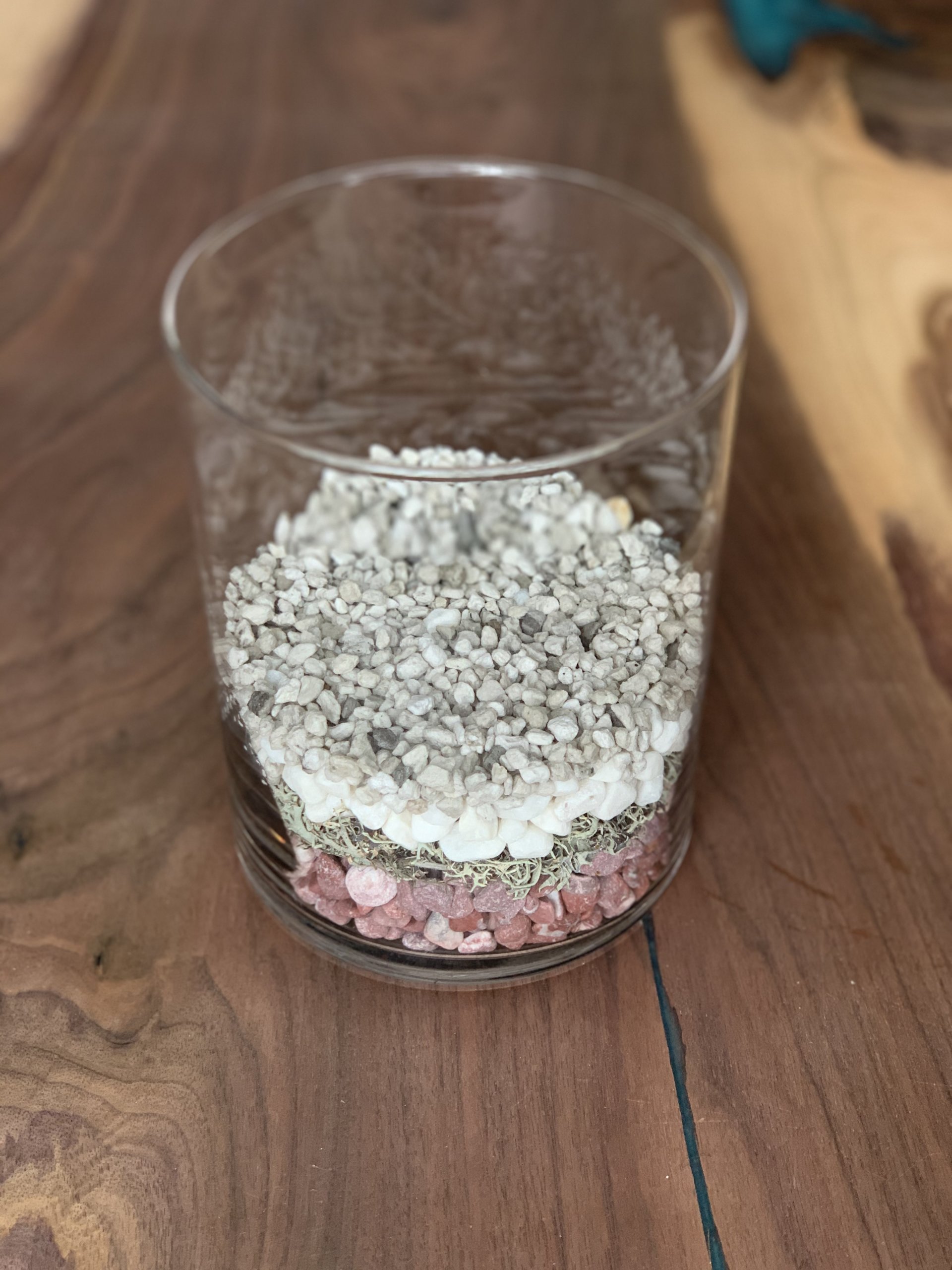 Decorative stones and lava rocks in glass vase