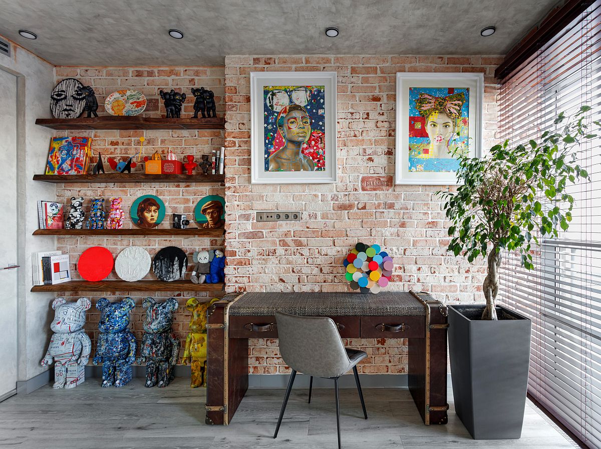 Industrial home office with modern decor and a brick wall backdrop