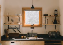 Kitchen sink with square window and shelves