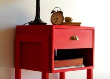 Lampshade and clock on top of a red drawer