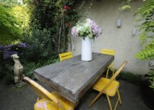 Large-rustic-wooden-table-and-four-colorful-chairs-in-yellow-sit-at-the-heart-of-this-shabby-chic-patio-39666-217x155