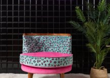 Leopard chair in light blue and pink beside a tall plant