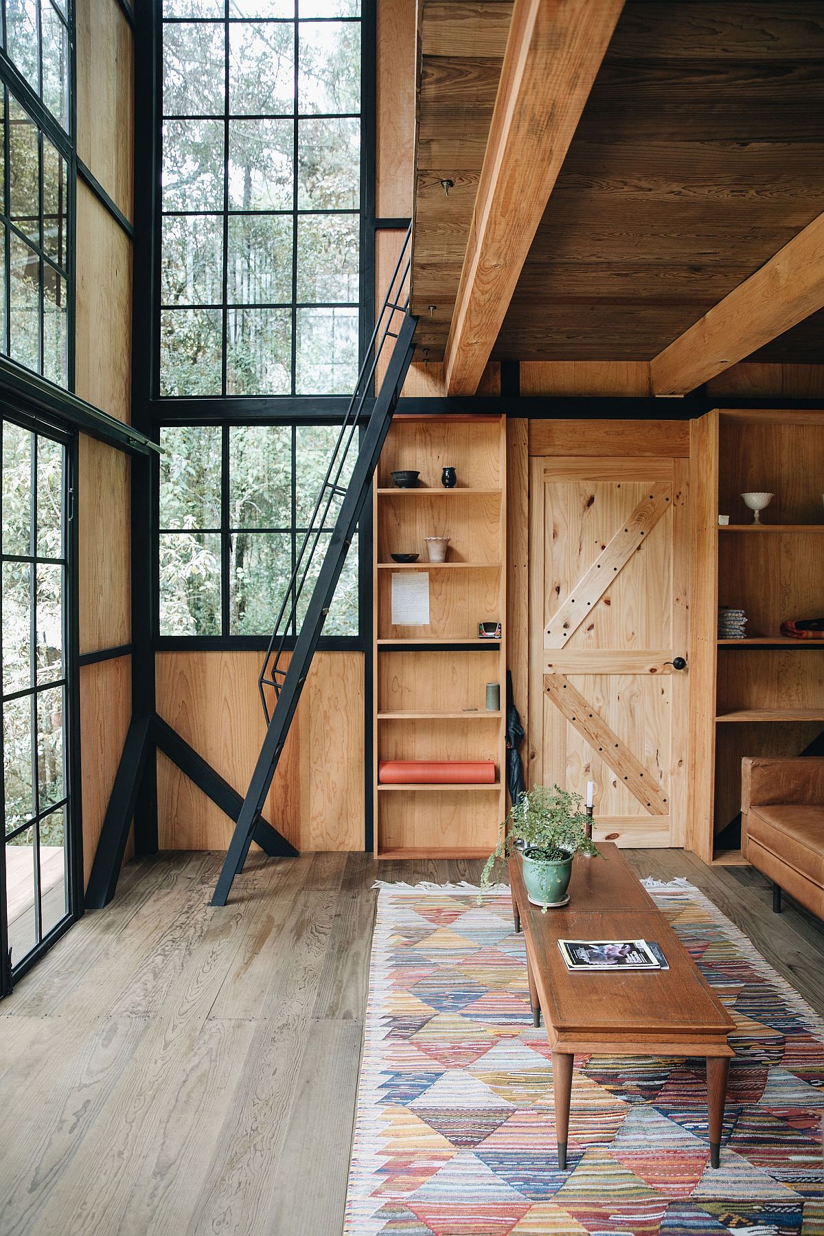 Locally sourced pine wood coupled with glass and metal windows inside the stylish cabin