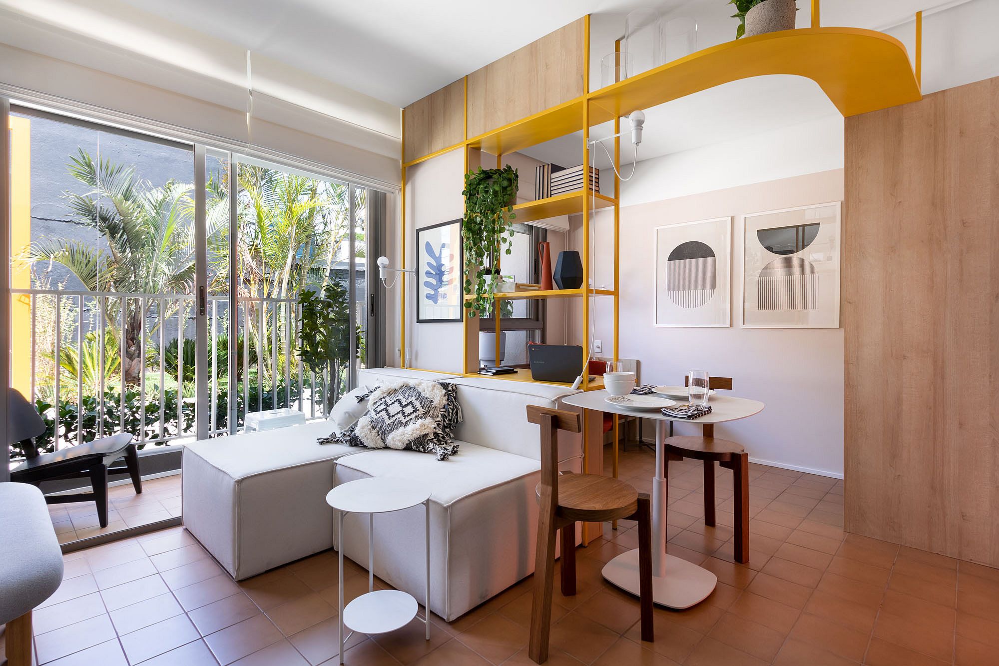 Metallic home workstation in yellow brings a splash of color to the living room in white and wood