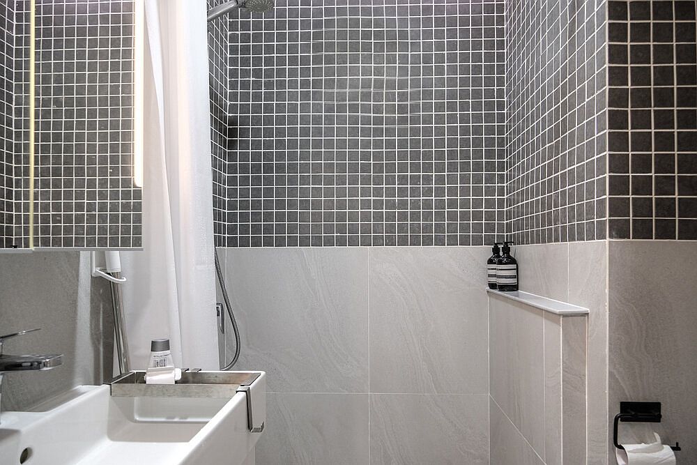 Modern bathroom in black and white with shades of gray thrown into the mix