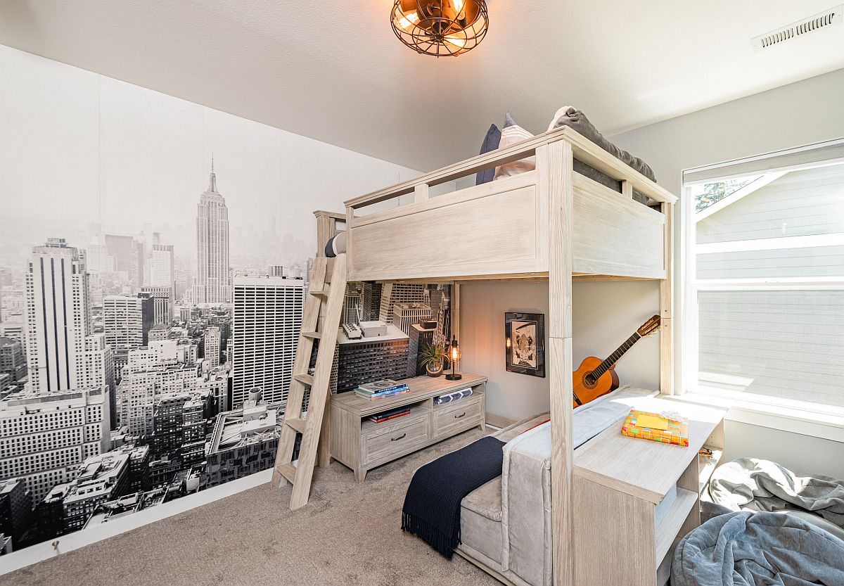 Modern industrial boys' bedroom with a lovely wall mural in the backdrop and a loft bed featuring study space underneath