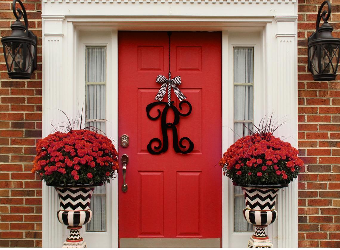 Red door with red flowers on the sides