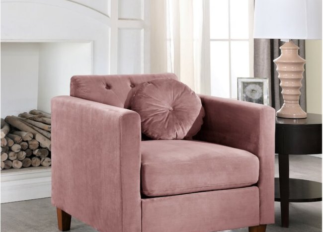 Rose Color Armchair With Round Cushion Beside A Table And A Lamp 92597 650x467 