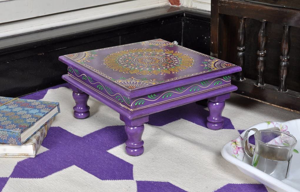 Small purple table with a purple and white carpet underneath
