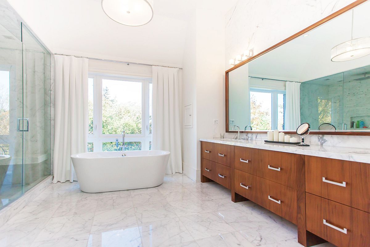 Sweeping contemporary bathroom next to the master bedroom with wooden vanity and marble flooring