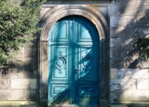 Turquoise arched door in gray wall