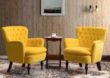 Two huge yellow chair with small coffee table in the middle