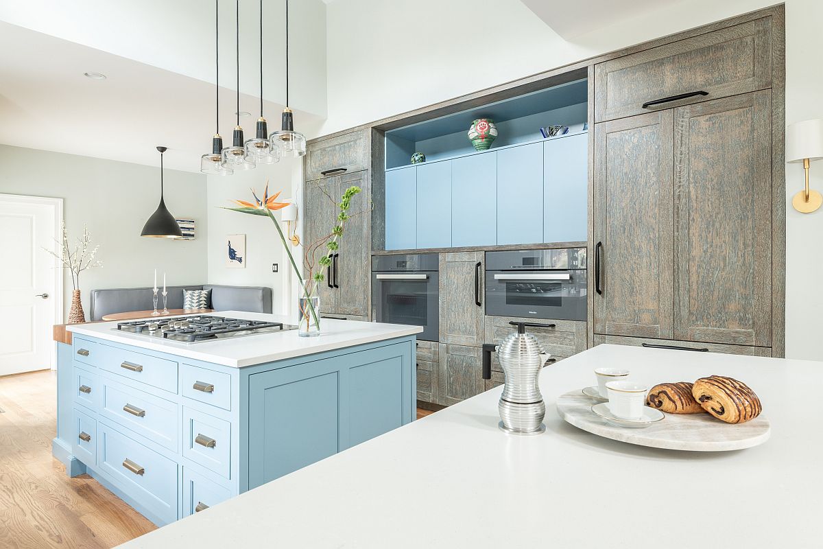 Uber-light blue cabinets along with a matching kithen island usher in subtle beach style