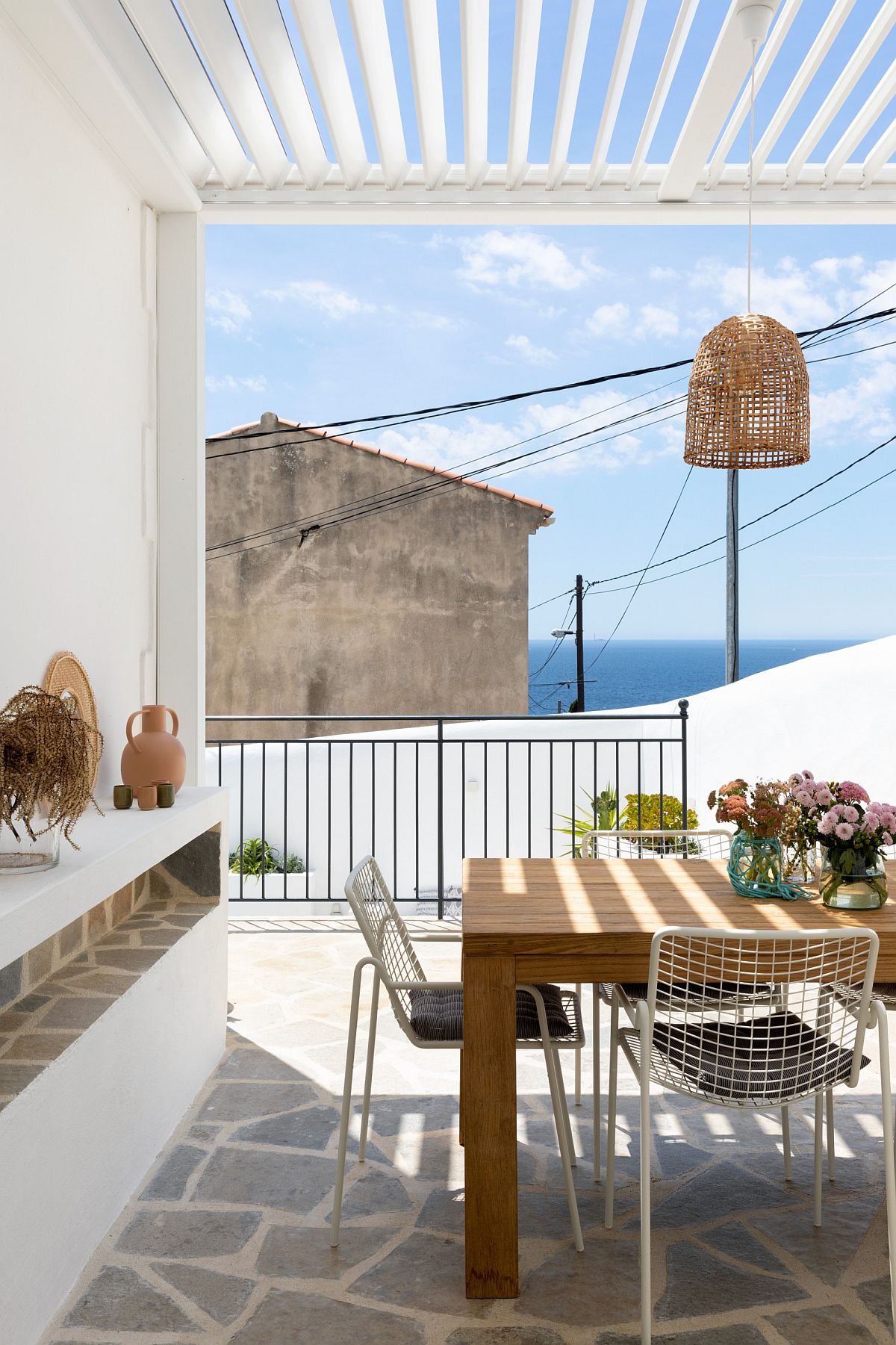 Understated modern patio in white can be easily turned into one with charming Mediterranean style