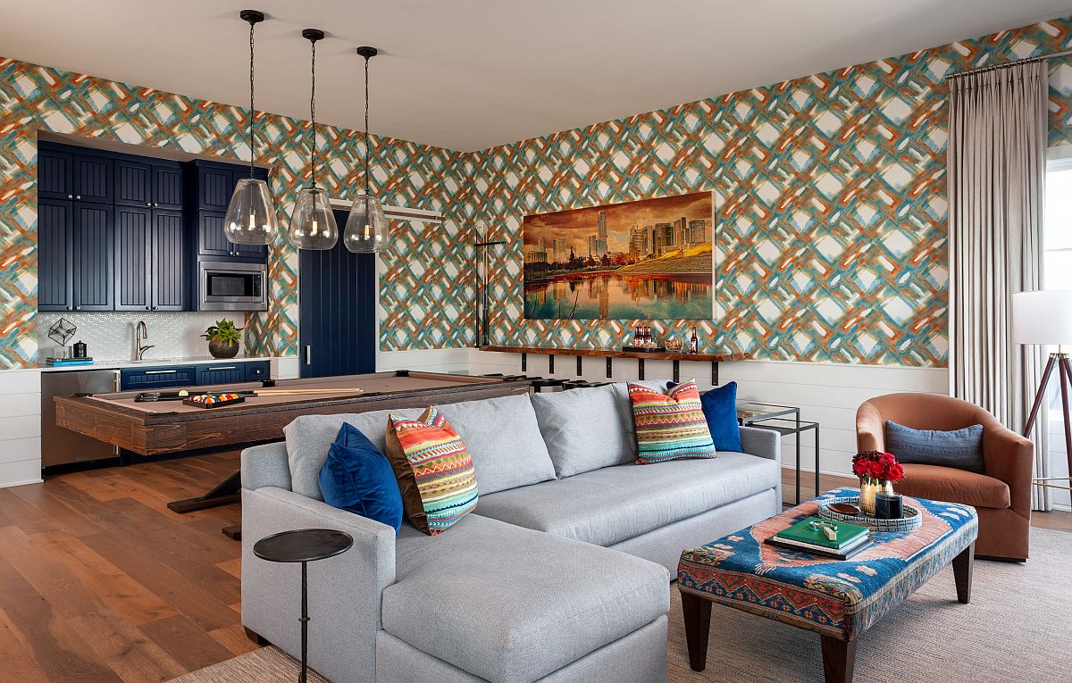 Wallpaper creates a colorful and pattern filled backdrop in this family and game room