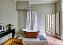 White and brown bath tub on top of elevated tile floor