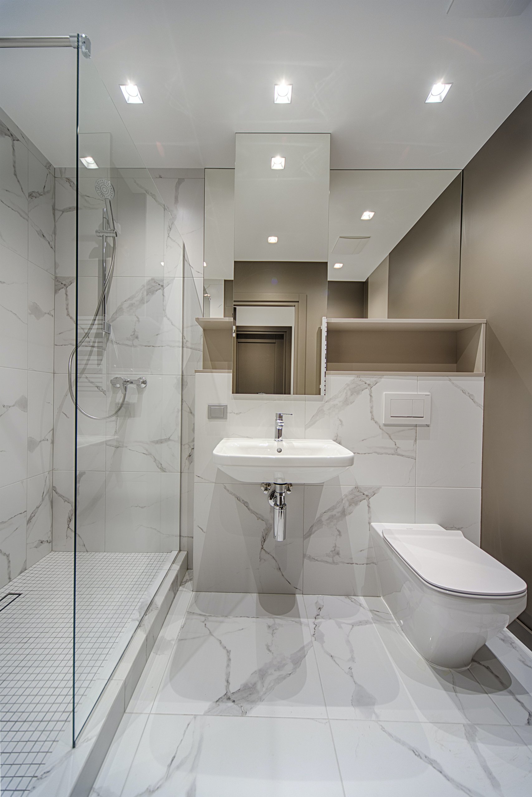 White bathroom with marble floor and walls