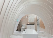 White bathroom with marble floor and white arcs