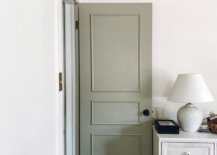 White lamp on white cabinet and an open door