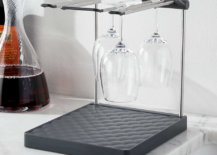 Wine glass drying rack beside a half-full wine flask