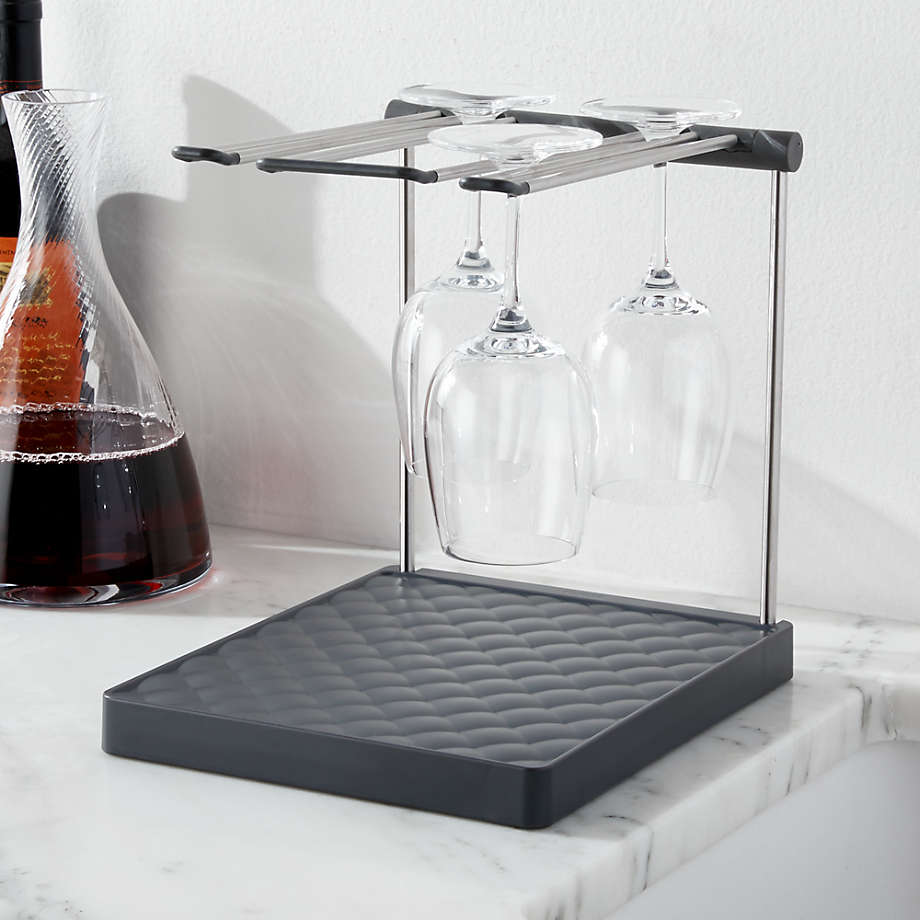 Wine glass drying rack beside a half-full wine flask