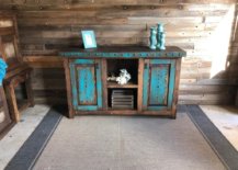 Wood cabinet with patches of blue paint