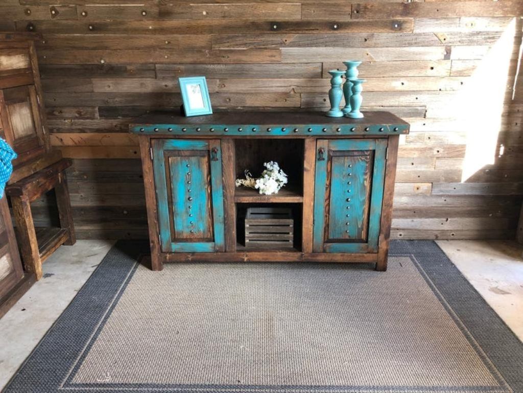 Wood cabinet with patches of blue paint