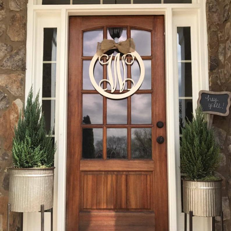 Wooden door with glass panels and monogram door hanger