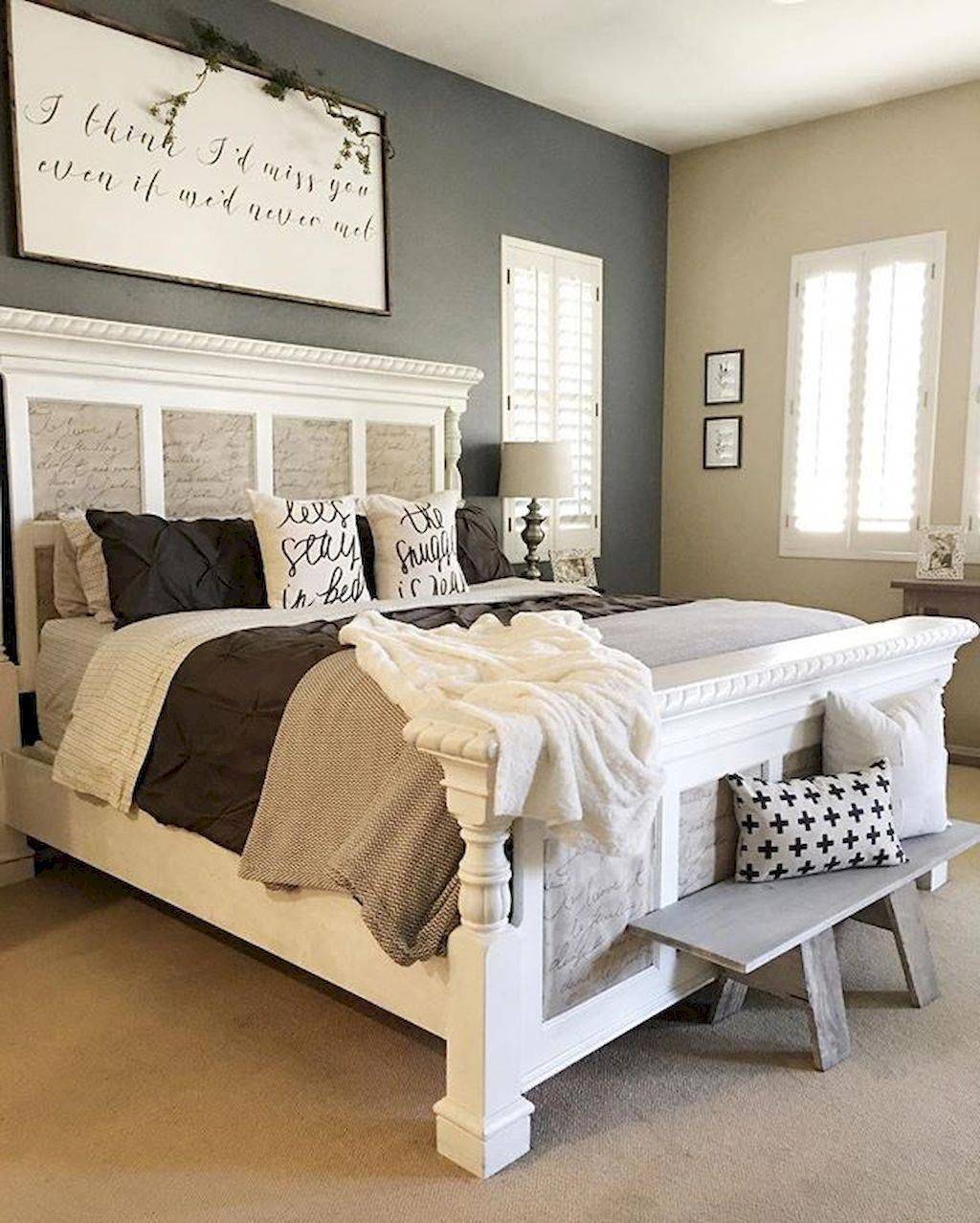 farmhouse style bedroom with inscription sign mounted above bed