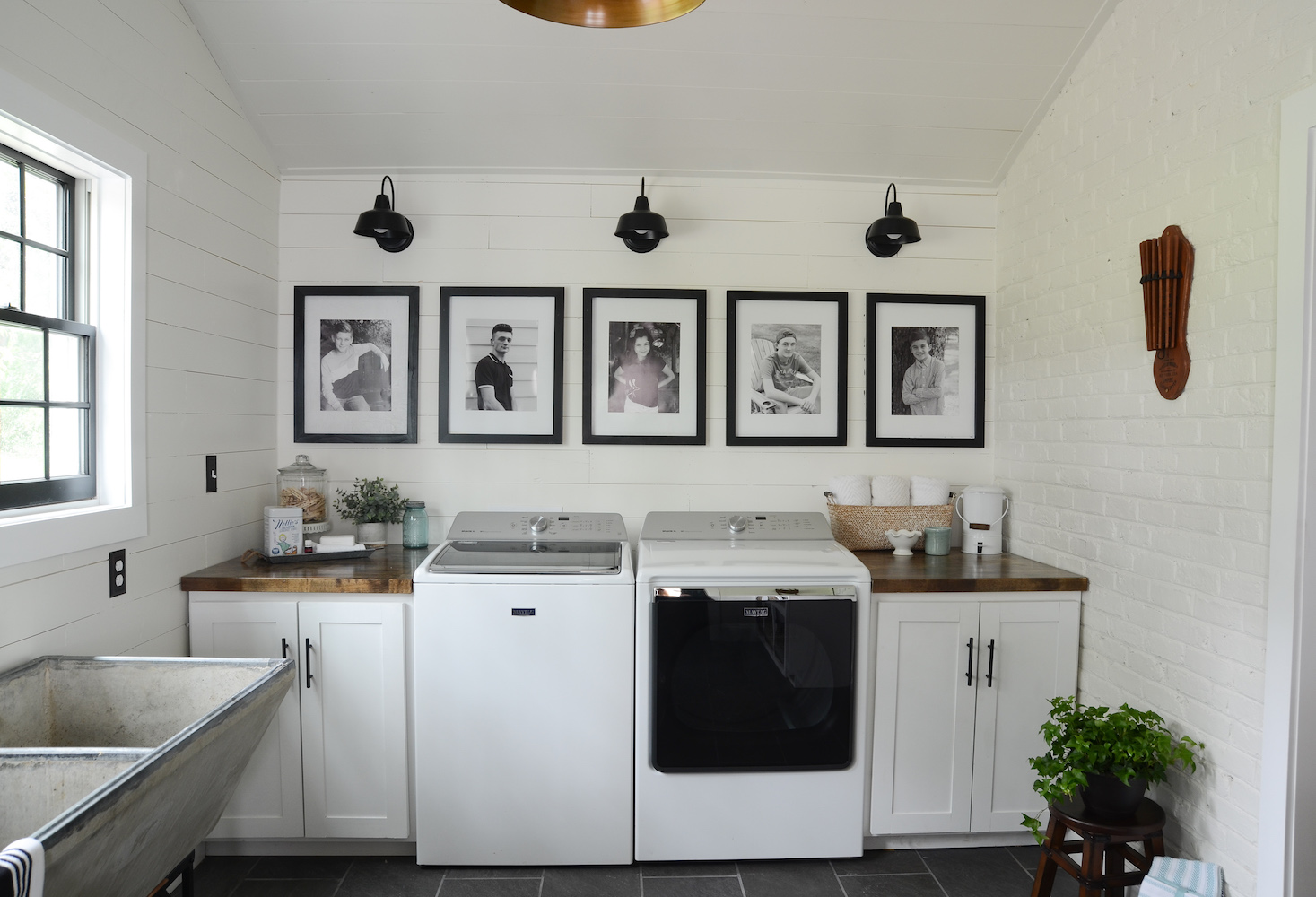 Black and white photos hanging on the wall in the laundry room